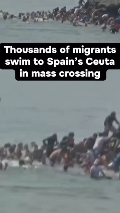 Video footage shows hundreds of migrants crossing into Spain's North African enclave of Ceuta on Thu