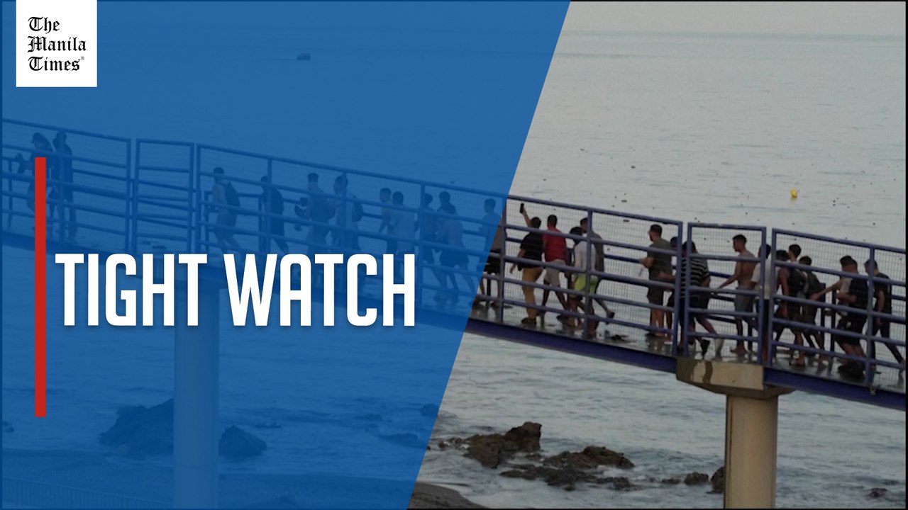Crowds of migrants enter Ceuta as Spain reinforces border police