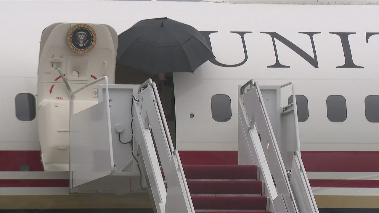 Trump and military escort share awkward umbrella moment on Tarmac