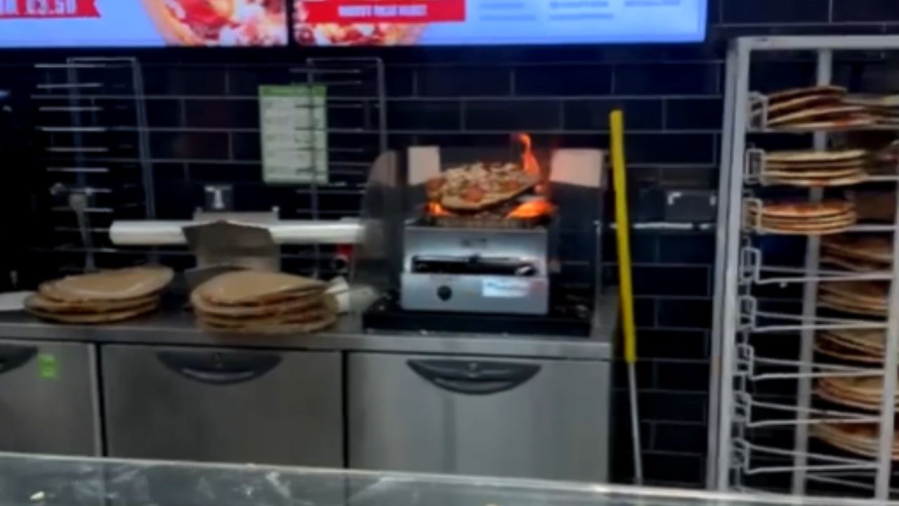Staff Attempt To Smother Flames On Smoking Machine In Asda Store