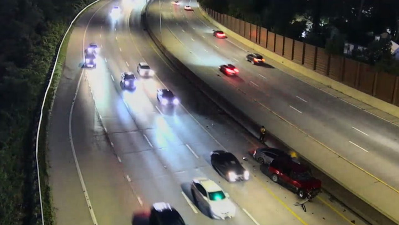 Stranded driver leaps out of way as car smashes into his disabled vehicle on highway
