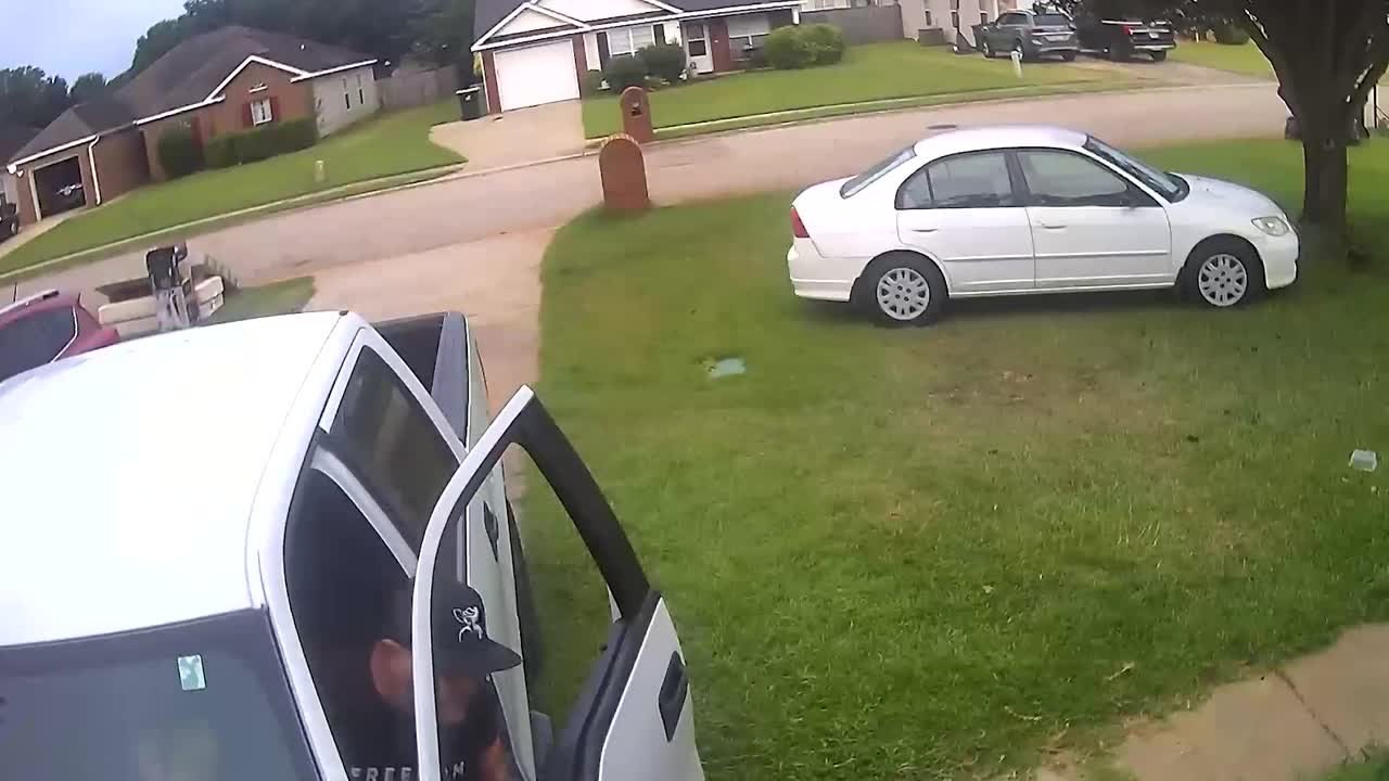 Driver's Empty Truck Rolls Into Garage After Hitting Trash Can