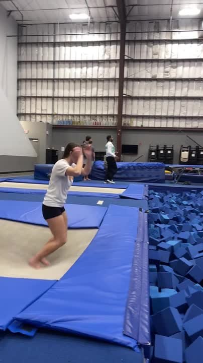 Woman's Feet Get Stuck on Mat Covering Trampoline Springs While Attempting Jump Trick