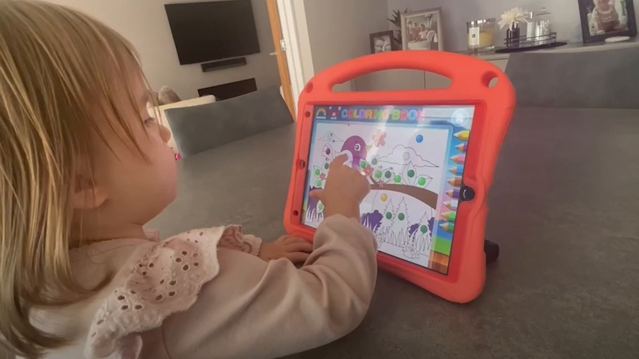 Baby Ella plays educational games on her iPad
