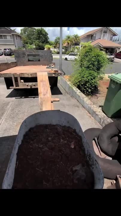 Man Falls While Pushing Wheelbarrow Up Ramp