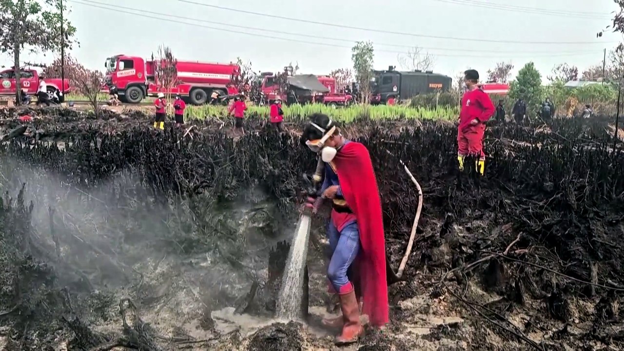 'Fight against the flames': Indonesian teenage 'Superman' helps father put out wildfires
