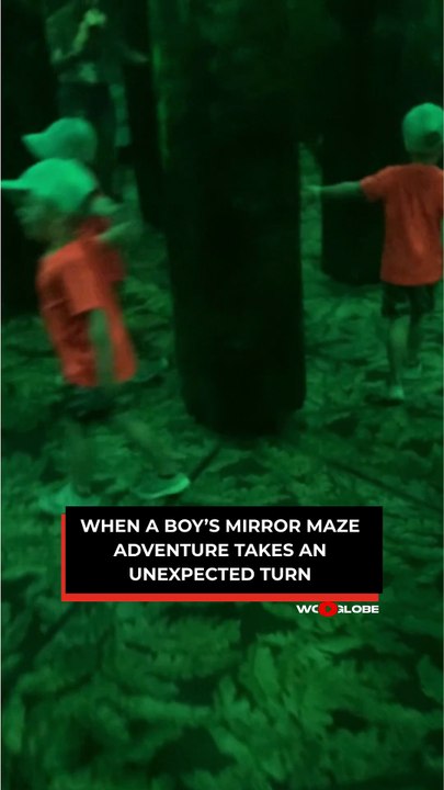Young boy faces a surprising moment in a mirror maze