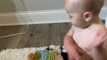 Adorable baby eagerly points to his favorite book for mom to read