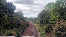 Duke of Gloucester steam train passes under Truro bridge