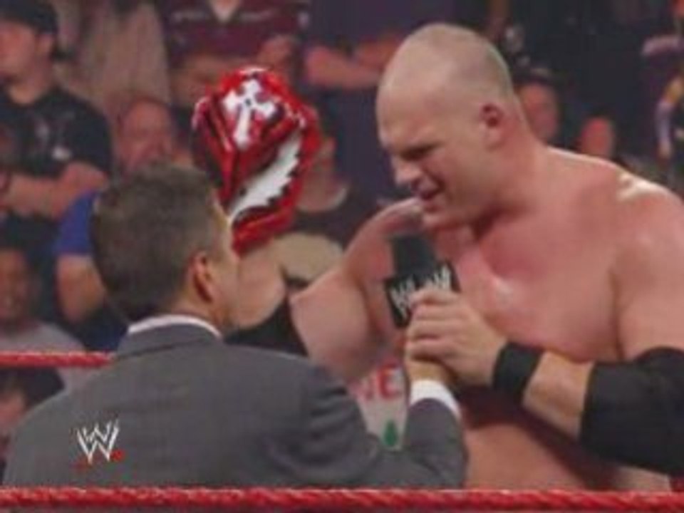 Kane opens the bag with Rey Mysterio's mask inside