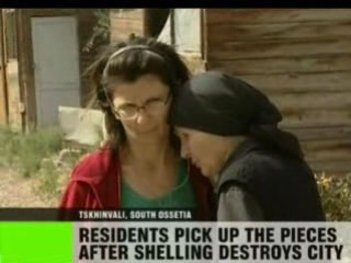 Residents pick up the pieces after shelling destroys city.