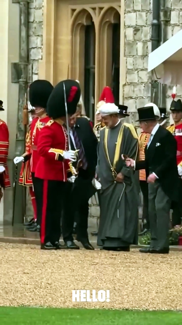 King Charles offers umbrella to Sultan of Oman