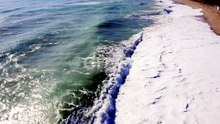 Turquoise Ocean Waves Crashing onto Sandy Beach