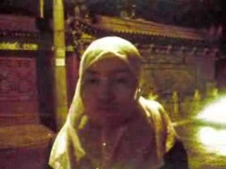 Chinese muslim reading koran on the street