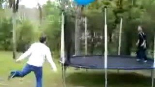 Kid on Trampoline Gets Whacked by Big Ball