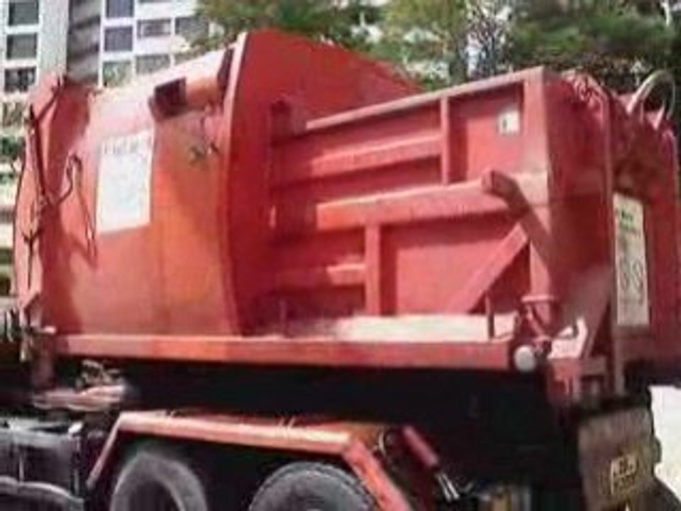 Truck hauling Garbage Compactor