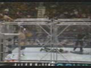 Tronch-Billy Gun backdrops Jeff Hardy over stell cage.