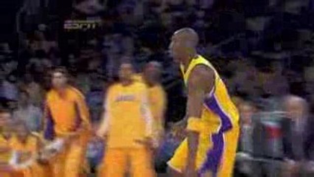 Kobe Bryant drives and drops one over the Denver defense in
