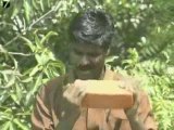 Madras, India: Man eats bricks, rocks, gravel