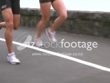 Joggers running showing muscles in slow motion