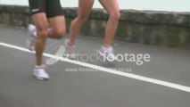Joggers running showing muscles in slow motion