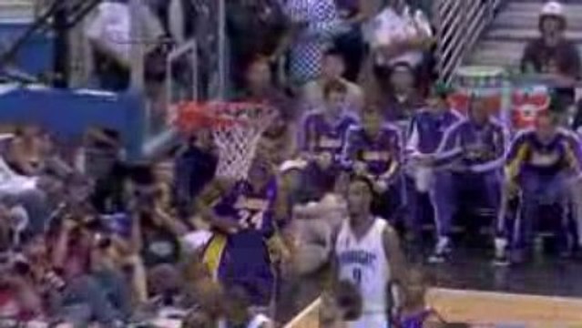 Kobe Bryant drives hard between three Magic players and gets