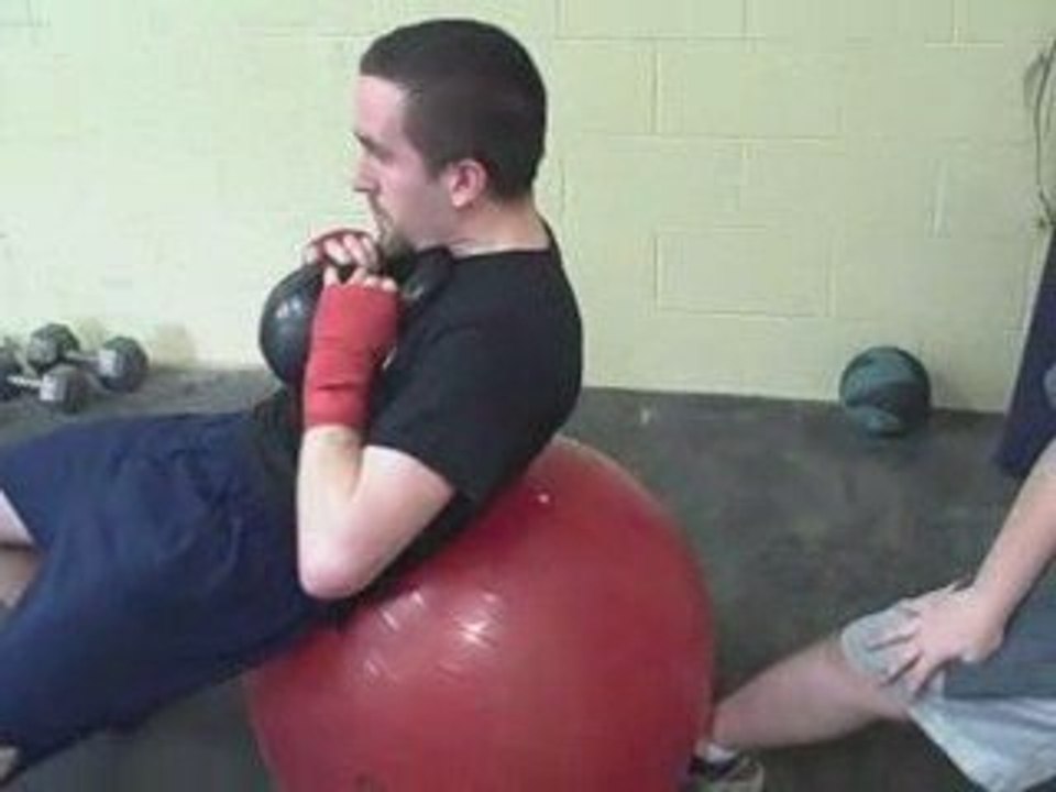 Loaded Swiss Ball Crunch Abdominal Exercise.